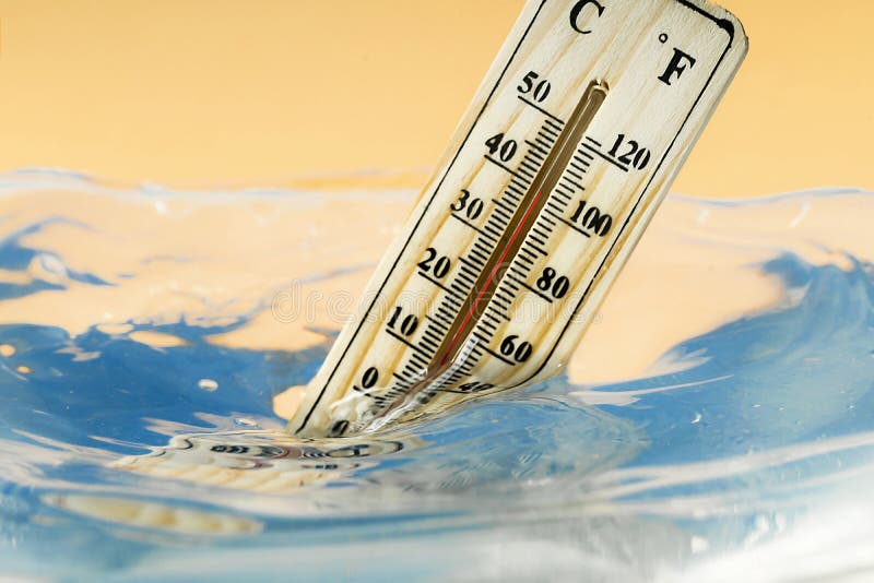 Climate change concept, wooden thermometer immersed in water. Climate change concept, wooden thermometer immersed in water