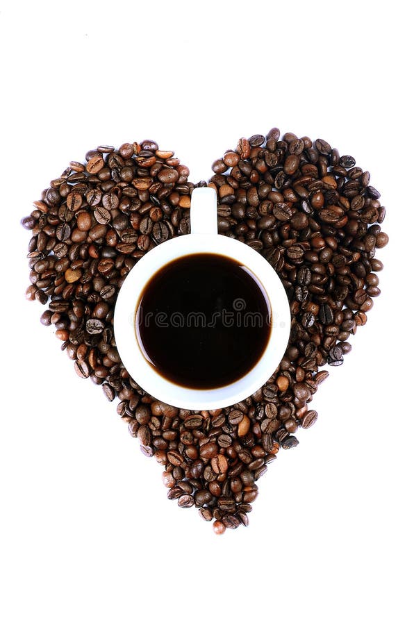 A white cup filled with coffee in the middle of heart shaped coffee beans. A white cup filled with coffee in the middle of heart shaped coffee beans.