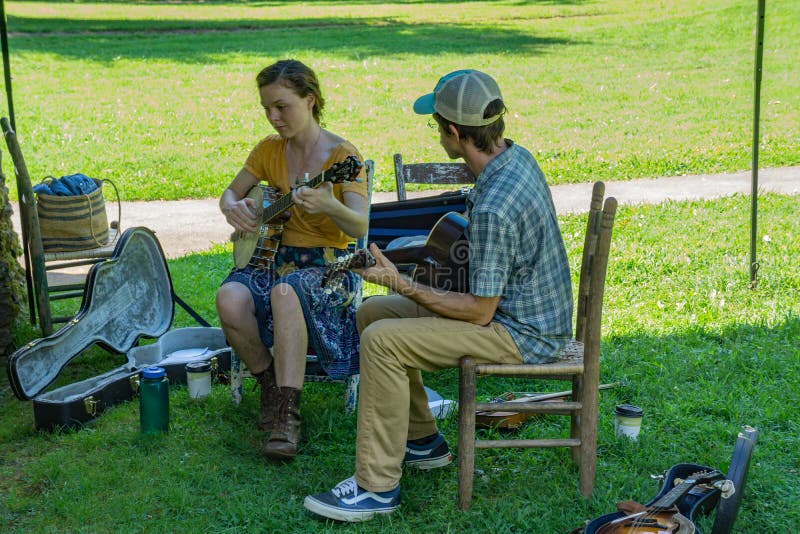 Floyd County, VA, August 18th, 2019: Couple playing mountain music at Mabry Mill on the Blue Ridge Parkway on August 18th, 2019, Floyd County, Virginia, USA. Floyd County, VA, August 18th, 2019: Couple playing mountain music at Mabry Mill on the Blue Ridge Parkway on August 18th, 2019, Floyd County, Virginia, USA.