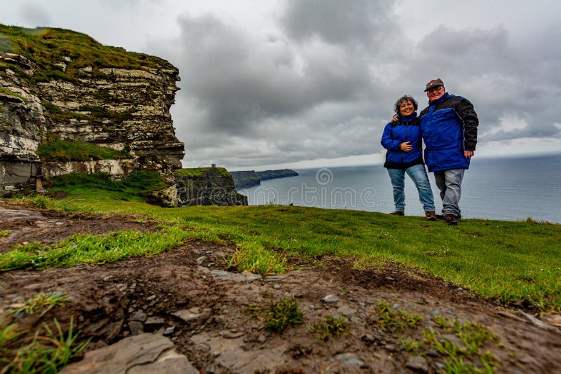 Koppla ihop av handelsresande med blåa omslag på klipporna av Moher arkivbild Koppla ihop av handelsresande med blåa omslag på klipporna av Moher arkivbild