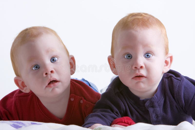 Beautiful baby twins lying on a blanket. Beautiful baby twins lying on a blanket