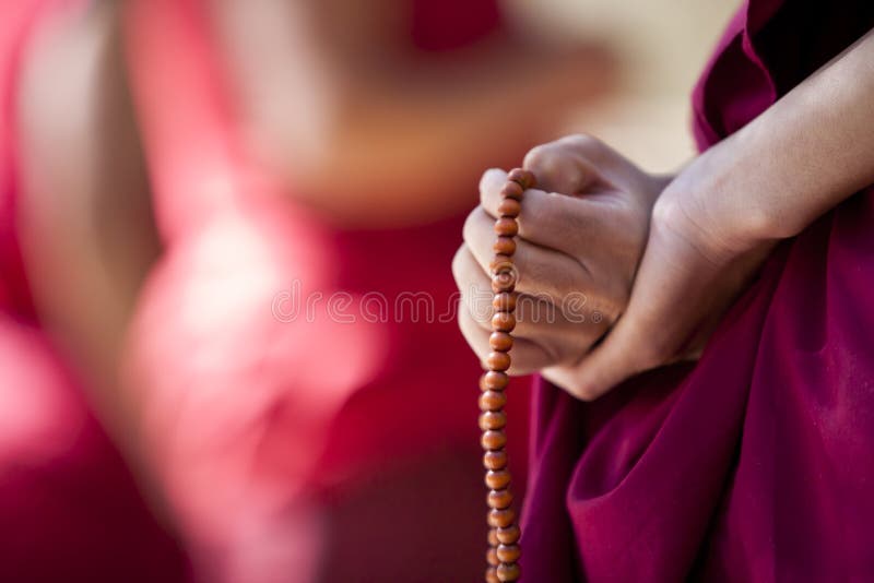 A monk in debate with hands clasped behind back, prayer beads in his hand, Sera Monastery, Lhasa, Tibet. A monk in debate with hands clasped behind back, prayer beads in his hand, Sera Monastery, Lhasa, Tibet.