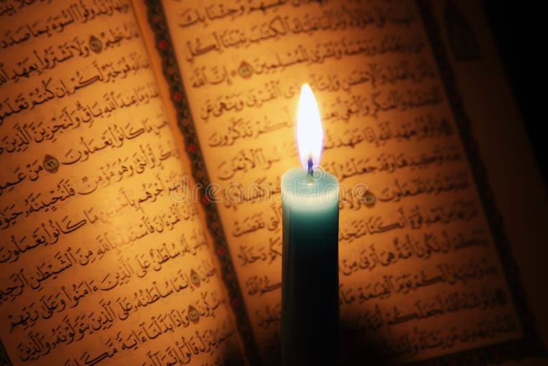 Koran or quran holy book with candle on candlelight royalty free stock image Koran or quran holy book with candle on candlelight royalty free stock image