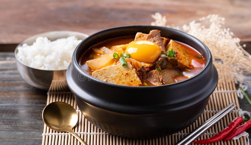 Korean Food, Kimchi Soup with Tofu, Pork and Fresh Egg Yolk Stock Photo