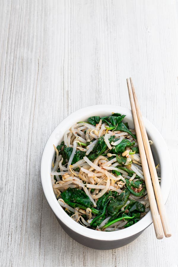 Korean Spinach Mung Bean Sprouts Salad on White Wooden Table Stock