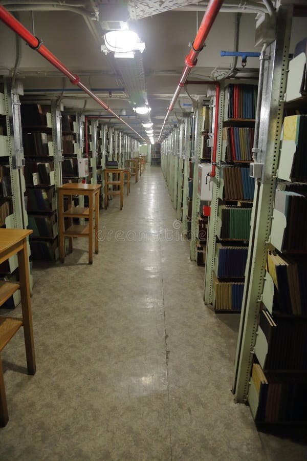 Long corridor with iron shelves with books. Long corridor with iron shelves with books