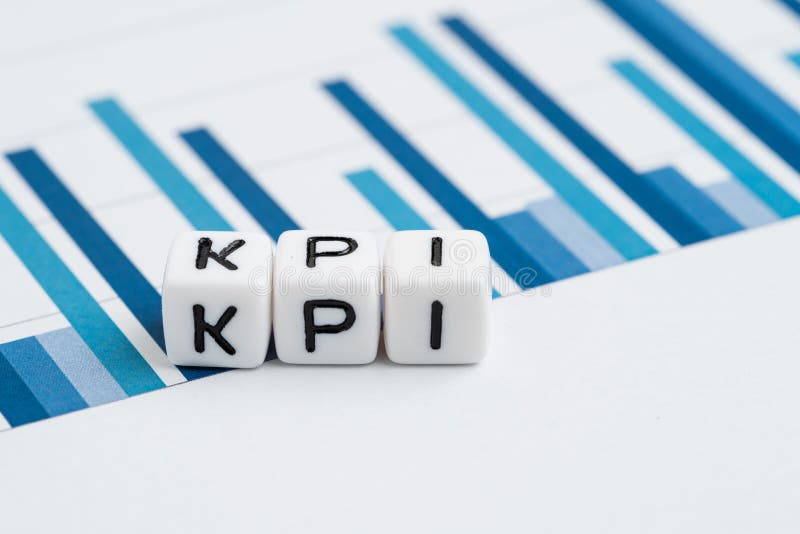 KPI, Key Performance Indicator concept, small cube block with alphabets building the word KPI on yearly chart and graph reports stock photos KPI, Key Performance Indicator concept, small cube block with alphabets building the word KPI on yearly chart and graph reports stock photos