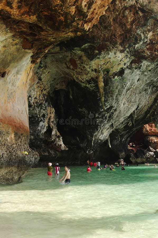 KRABI THAILAND - OKTOBER 27, 2013: pittoresk ren klippa ovanför havet med simningfolk arkivbild KRABI THAILAND - OKTOBER 27, 2013: pittoresk ren klippa ovanför havet med simningfolk arkivbild