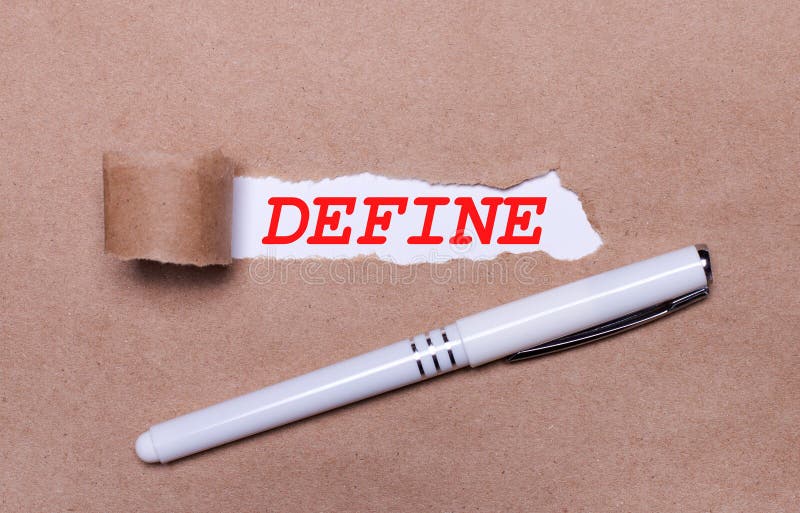 On Kraft Paper, a White Pen and a White Strip of Paper with the Text DEFINE Stock Photo Image