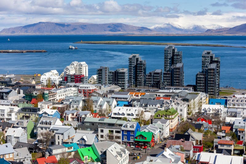 Reykjavik, Iceland, 14.05.22. Reykjavik cityscape with colorful residential buildings and modern skyscrapers, ocean view and snowcapped Mount Esjan seen from Hallgrimskirkja church tower. Reykjavik, Iceland, 14.05.22. Reykjavik cityscape with colorful residential buildings and modern skyscrapers, ocean view and snowcapped Mount Esjan seen from Hallgrimskirkja church tower