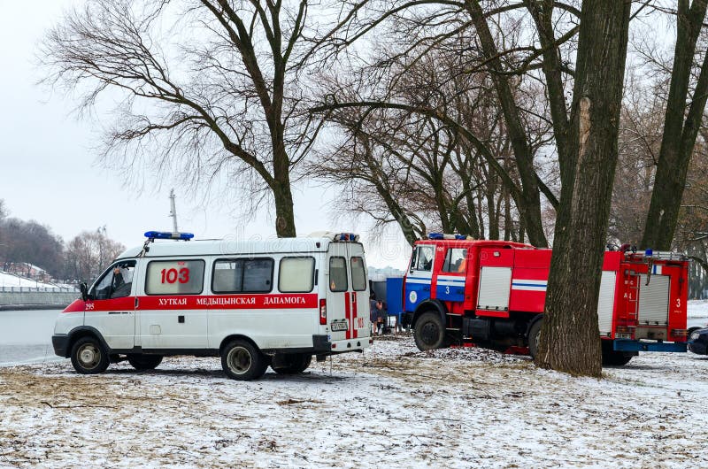 GOMEL, BELARUS - JANUARY 19, 2015: Ambulance crews and the Emergencies Ministry are on duty on the river Sozh in Gomel during the traditional Epiphany bathing. GOMEL, BELARUS - JANUARY 19, 2015: Ambulance crews and the Emergencies Ministry are on duty on the river Sozh in Gomel during the traditional Epiphany bathing