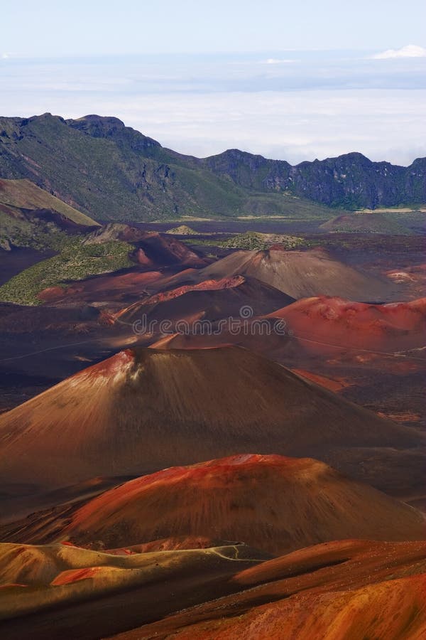 View of Haleakala volcanic crater detailing the red cinders of past eruptions resembling the landscape of the planet Mars. View of Haleakala volcanic crater detailing the red cinders of past eruptions resembling the landscape of the planet Mars
