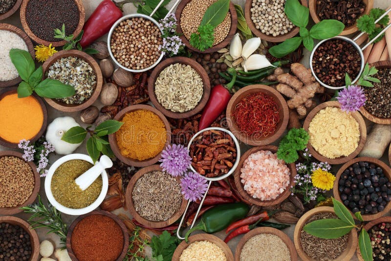 Herb and spice seasoning in wooden bowls, scoops and mortar with pestle. High in antioxidants and vitamins. Top view. Herb and spice seasoning in wooden bowls, scoops and mortar with pestle. High in antioxidants and vitamins. Top view.