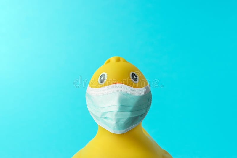 Creative composition with Yellow rubber duck with virus mask. Minimal Corona virus outbreak. Holiday concept. Creative composition with Yellow rubber duck with virus mask. Minimal Corona virus outbreak. Holiday concept.