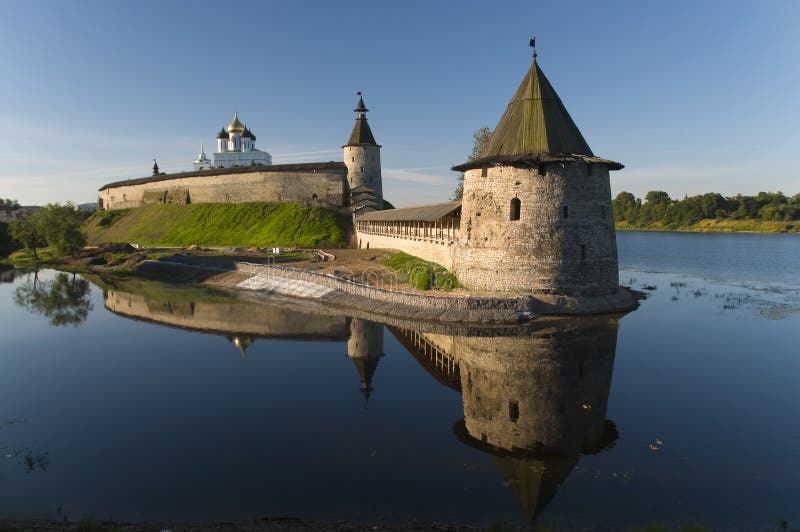 Towers of the fortress and the Christian church on the bank of the river. Pskov, Russia. Towers of the fortress and the Christian church on the bank of the river. Pskov, Russia