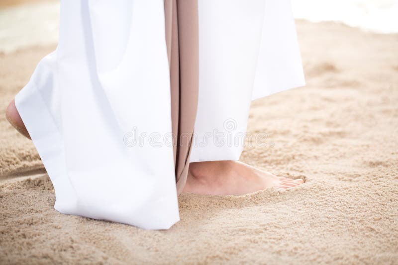 Jesus Christ walking barefoot on the sand. Jesus Christ walking barefoot on the sand