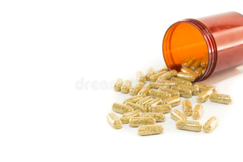 Kruidcapsules die uit fles morsen royalty-vrije stock fotografie Kruidcapsules die uit fles morsen royalty-vrije stock fotografie