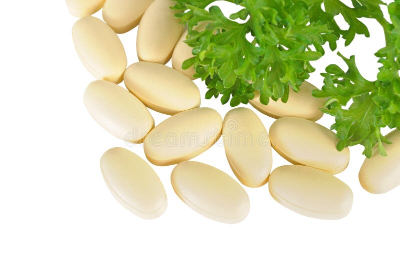 Herbal medical pills and green leaves of its ingredient on white. Herbal medical pills and green leaves of its ingredient on white