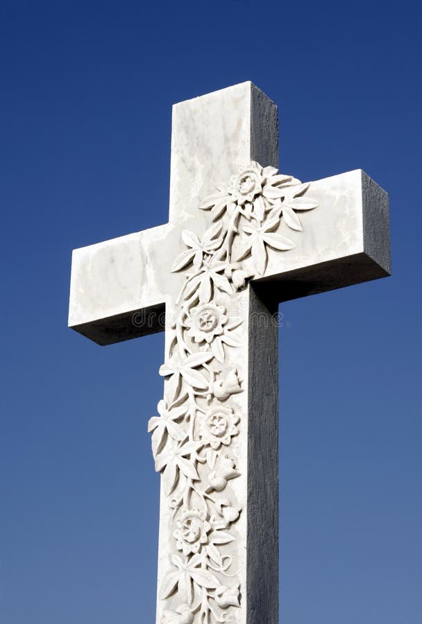 White Grave Stone Cross In Front Of Clear Blue Sky. White Grave Stone Cross In Front Of Clear Blue Sky