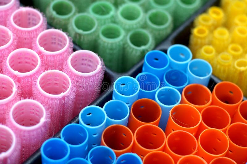 Colorful curlers sorted in a drawer at a beauty salon. Colorful curlers sorted in a drawer at a beauty salon.