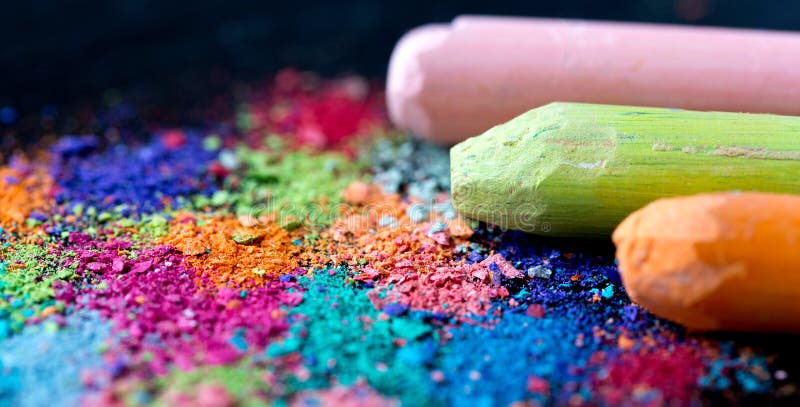 Crumbs of multi-colored chalk on a black background. Joy, Carnival, Panorama. A game for children. Art. Crumbs of multi-colored chalk on a black background. Joy, Carnival, Panorama. A game for children. Art.