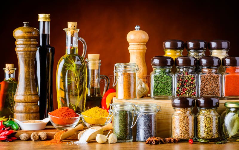 Bottles of oil and Balsamic vinegar and different spices and seeds and cooking ingredients. Bottles of oil and Balsamic vinegar and different spices and seeds and cooking ingredients