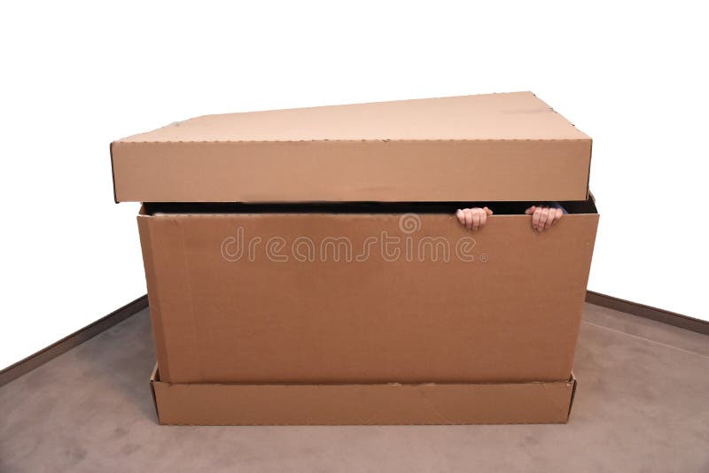 Child hidden in a gigantic paper box, playing hide and seek. Child hidden in a gigantic paper box, playing hide and seek