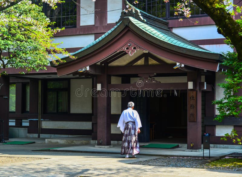 A priest coming to the ancient temple in Tokyo, Japan. A priest coming to the ancient temple in Tokyo, Japan