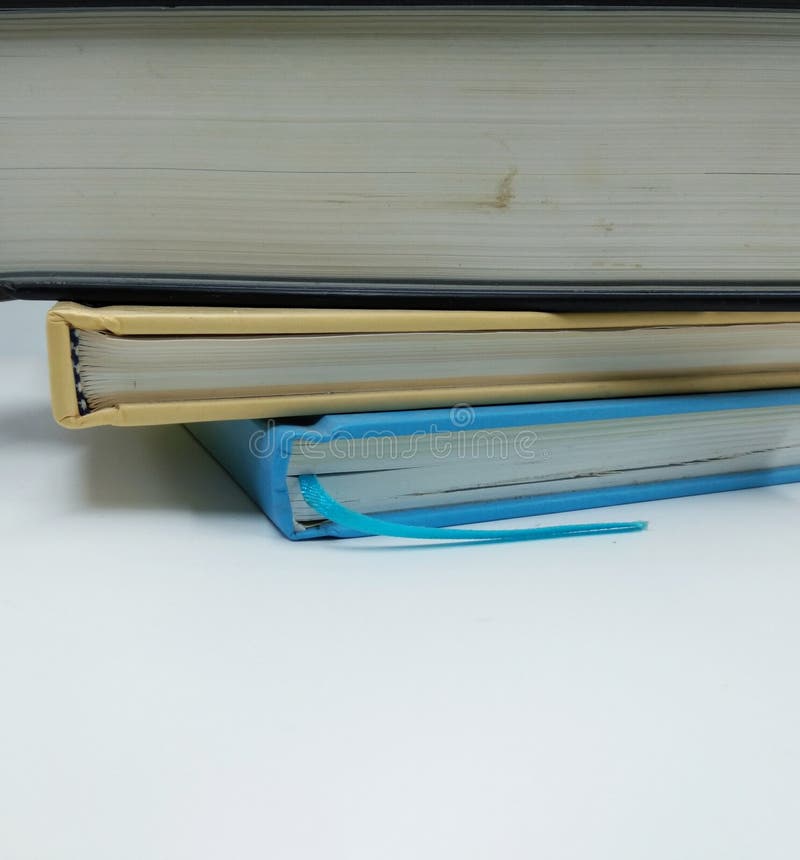 Books stacked on a white background  Give me ideas for reading books in preparation for the exam, a feeling of commitment, have goals, have to win success. Books stacked on a white background  Give me ideas for reading books in preparation for the exam, a feeling of commitment, have goals, have to win success.