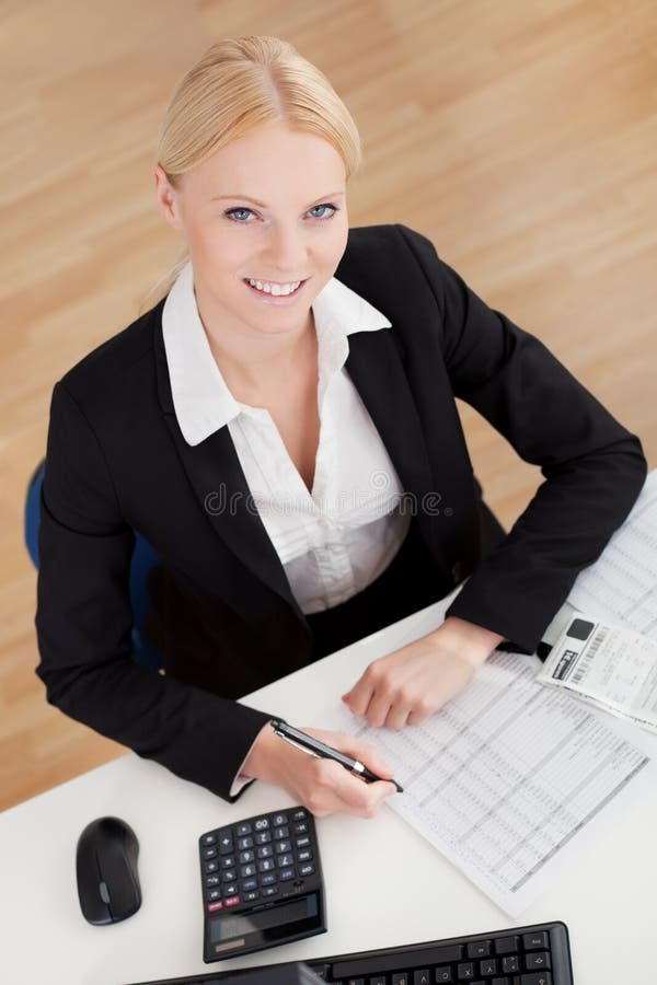 Cheerful accountant businesswoman working in the office. Cheerful accountant businesswoman working in the office