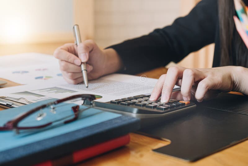 Accountant working with calculator for investigation of corruption account. Accountant working with calculator for investigation of corruption account.