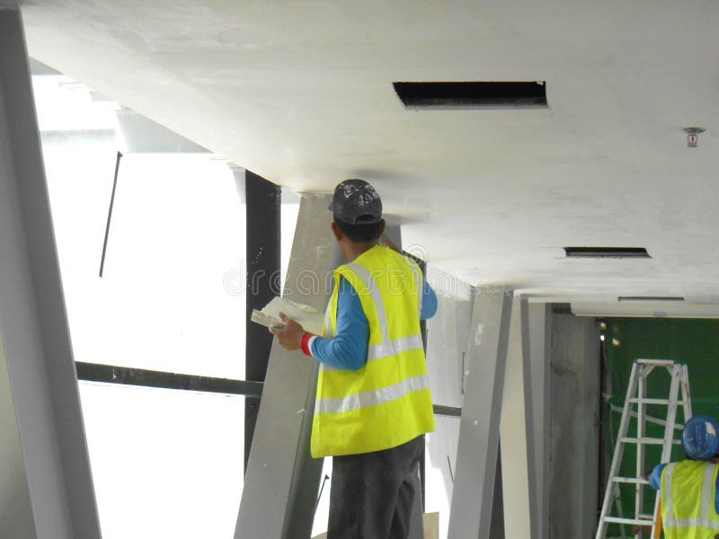 Construction Site Workers are Doing Ceiling Soffit Skim Coat Work at