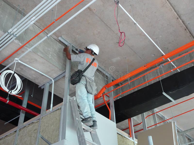 Drywall installation work in progress by construction workers at the construction site. stock photography Drywall installation work in progress by construction workers at the construction site. stock photography
