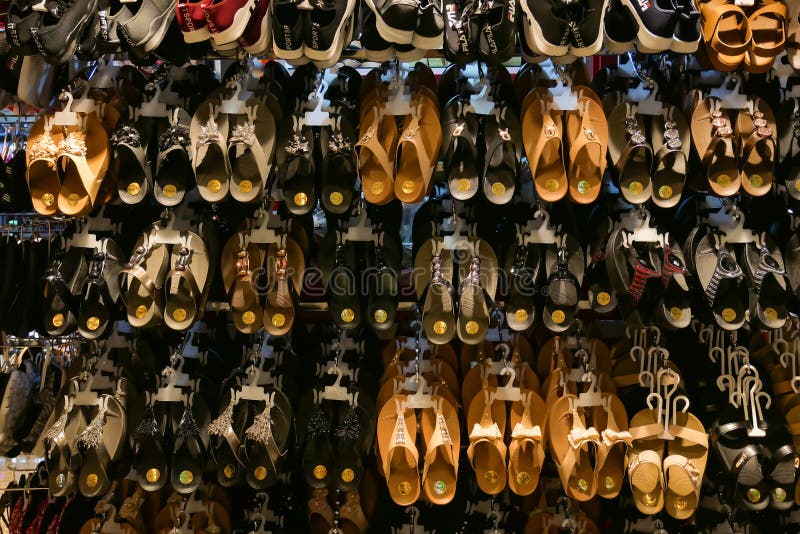 Various pair of slippers hang on the shelves and display at the store for selling stock photo Various pair of slippers hang on the shelves and display at the store for selling stock photo