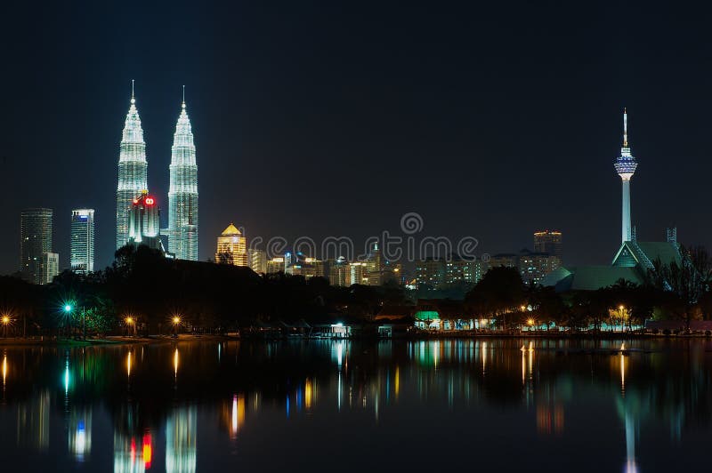 Skyline of Kuala Lumpur city at night with Petronas twin towers and TV tower reflecting in the pond in Kuala Lumpur, Malaysia. stock image Skyline of Kuala Lumpur city at night with Petronas twin towers and TV tower reflecting in the pond in Kuala Lumpur, Malaysia. stock image