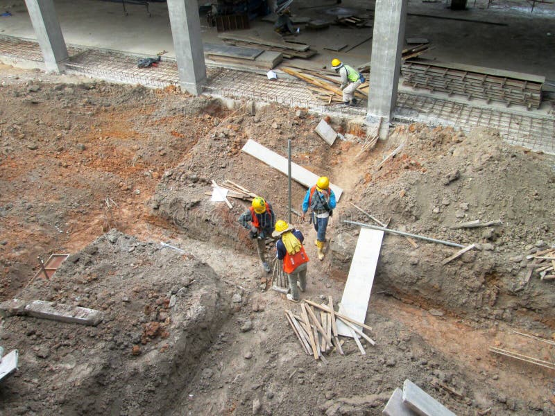 Construction workers installing & fabricating timber form works at the construction site.