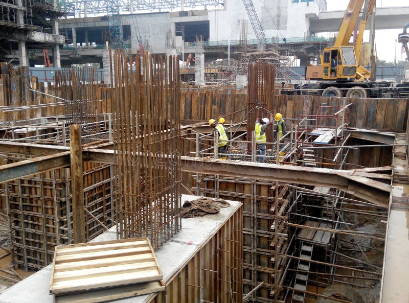 Construction Workers Installing Reinforcement Bar at the Construction Site. Editorial