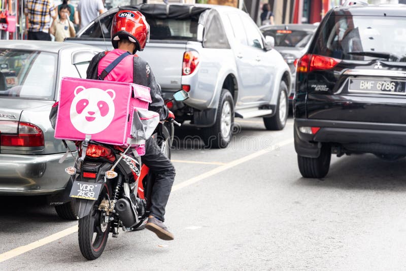 KUALA LUMPUR, MALAYSIA, September 17, 2019: Food order online via Foodpanda being delivered on motorbike by foodpanda rider.  Foodpanda is up coming online delivery company in Malaysia, app, application, asia, cashless, collaboration, convenience, service, digital, dinner, editorial, employment, job, lunch, motorcycle, people, phone, retail, services, technology, thermal, bag, transport, transportation