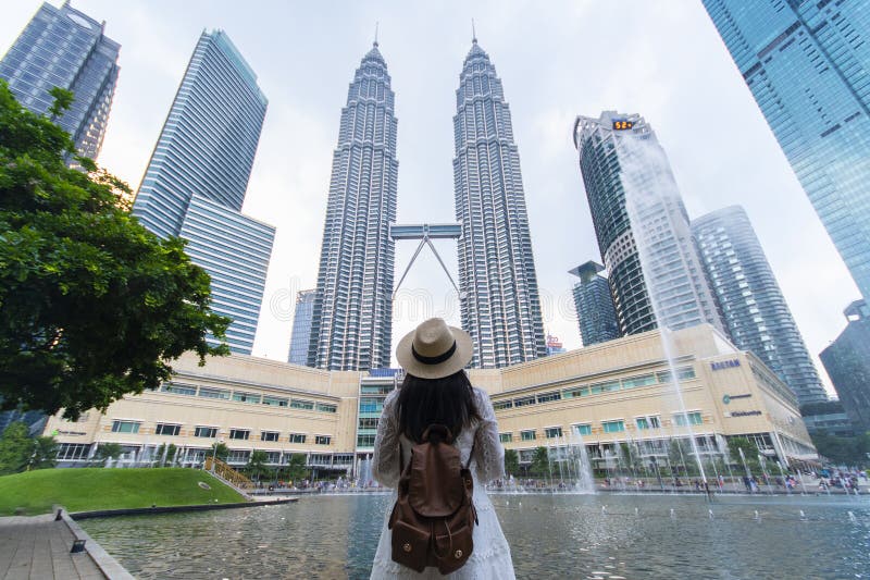 A woman tourist is sightseeing the Petronas Twin tower KLCC in Kuala Lumpur. stock images A woman tourist is sightseeing the Petronas Twin tower KLCC in Kuala Lumpur. stock images