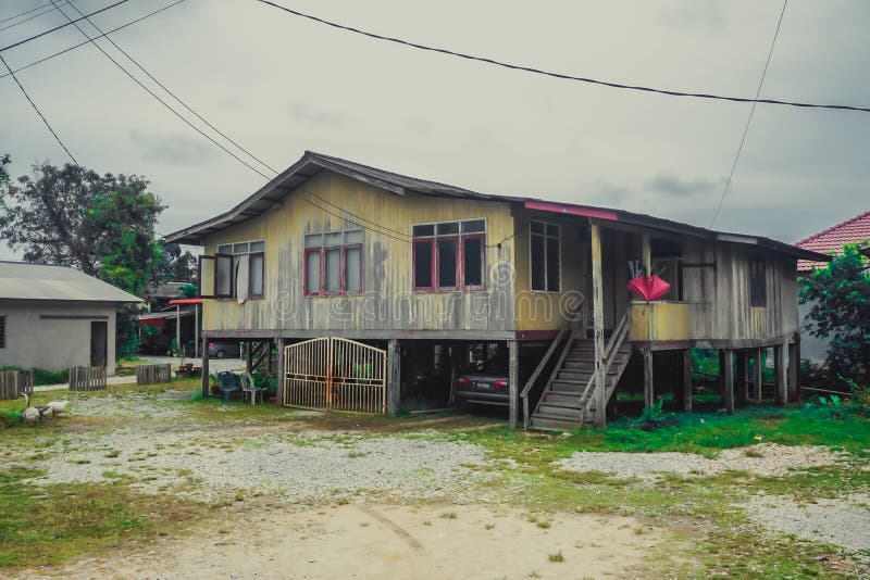 Kuala Terengganu, Malaysia - April 3, 2019: Ordinary rural house on stilts. Kuala Terengganu, Malaysia - April 3, 2019: Ordinary rural house on stilts.