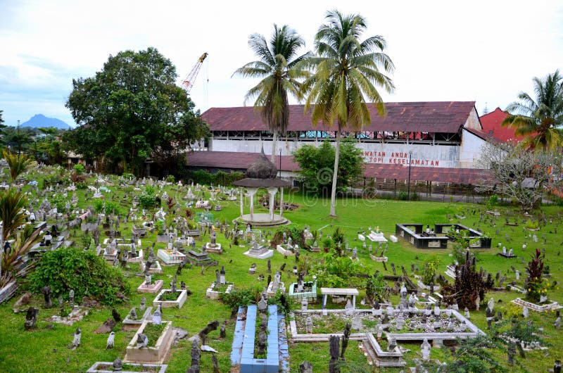 Muslim graveyard on sloping hill with Brooke Dockyard and crane Kuching Sarawak Malaysia