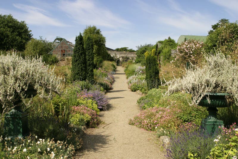 The kitchen garden at Glin is surrounded by high rock walls that can seen at the end of the gravel path. This private walled garden is the source of the flowers and organic greens used in the kitchen and dining rooms. The kitchen garden at Glin is surrounded by high rock walls that can seen at the end of the gravel path. This private walled garden is the source of the flowers and organic greens used in the kitchen and dining rooms.