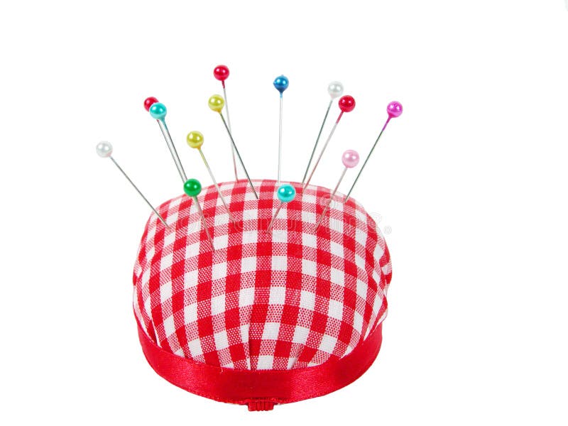 Pin cushion with pins over white background. Pin cushion with pins over white background