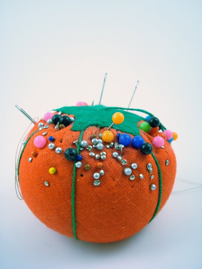 A pin cushion full of pins. A pin cushion full of pins