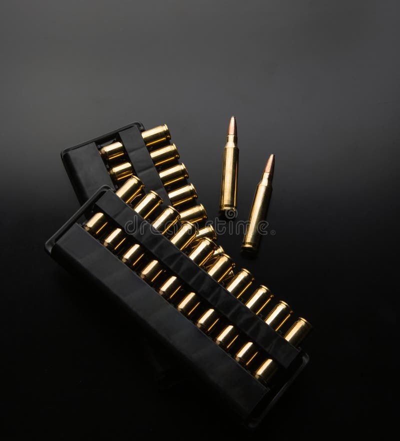 Bullet isolated on black background with reflexion. Rifle bullets close-up on black back. Cartridges for rifle and carbine on a black. Bullet isolated on black background with reflexion. Rifle bullets close-up on black back. Cartridges for rifle and carbine on a black