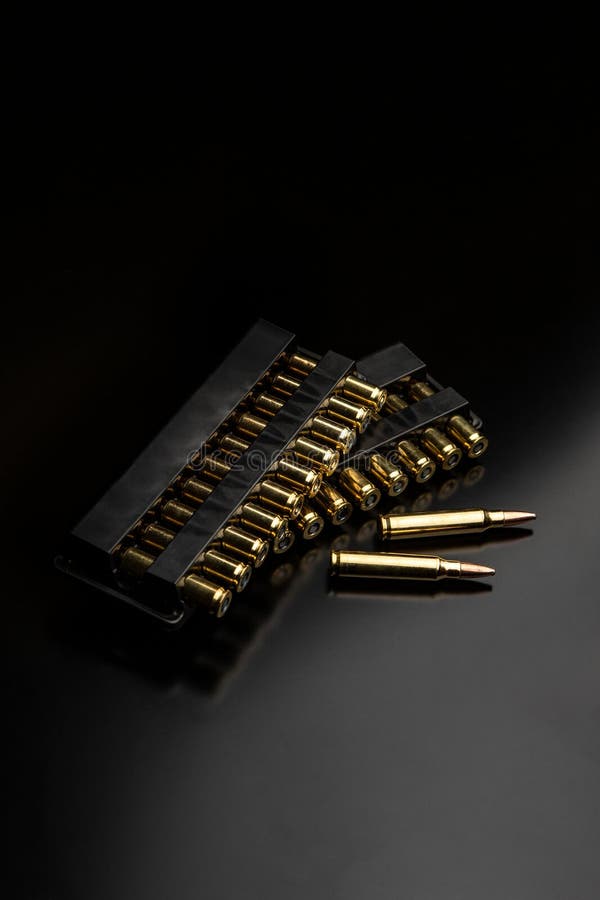 Bullet isolated on black background with reflexion. Rifle bullets close-up on black back. Cartridges for rifle and carbine on a black. Bullet isolated on black background with reflexion. Rifle bullets close-up on black back. Cartridges for rifle and carbine on a black