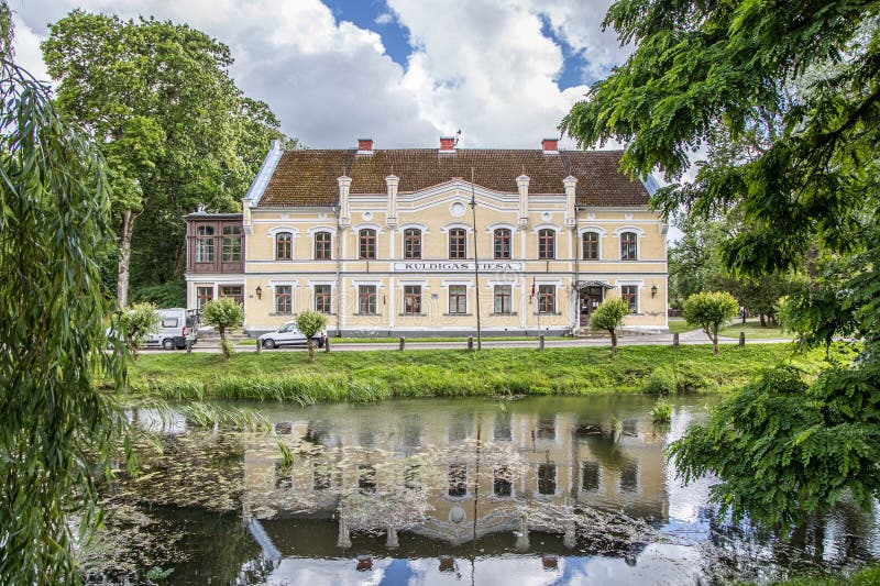 Kuldiga, Latvia - July 3, 2023: Kuldiga District Court with reflection in pond royalty free stock photo