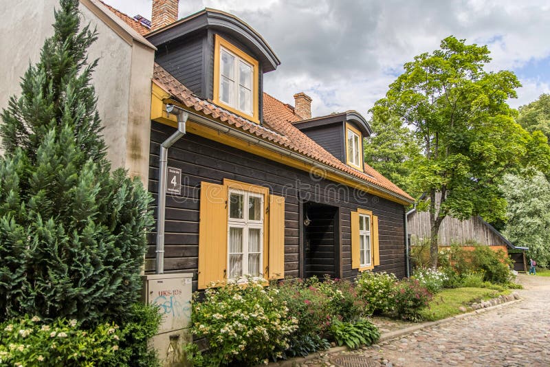 Kuldiga, Latvia - July 3, 2023: An old, historical brown yellow wooden house stock photos