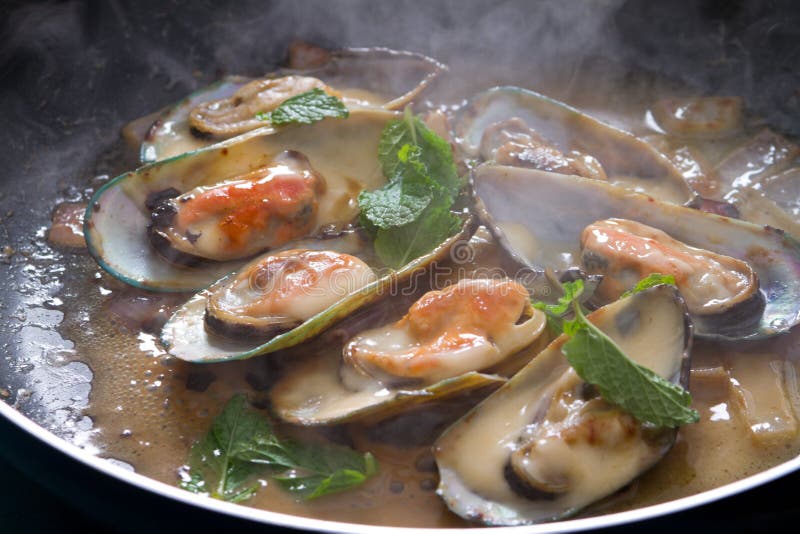 Fresh mussels cooking in frying pan. Fresh mussels cooking in frying pan