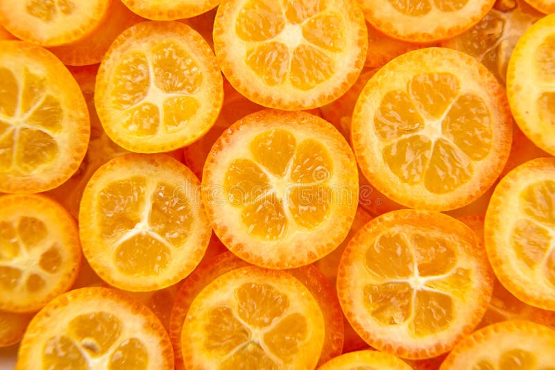 Kumquat citrus fruit slices background